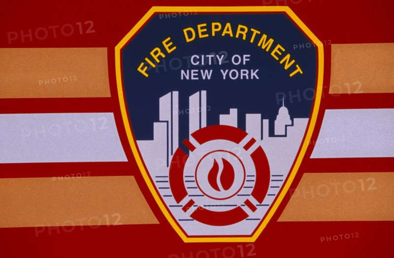 USA, New York, New York City, Detail of New York fire department badge on side of fire engine or truck.  Continues to depict city skyline including twin towers of the World Trade Centre.