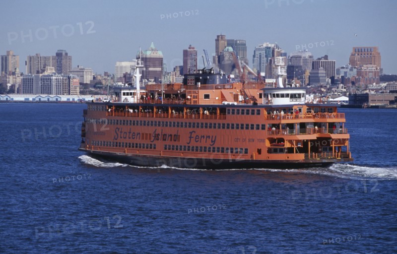 USA, New York, New York City, Staten Island ferry with city skyline beyond.