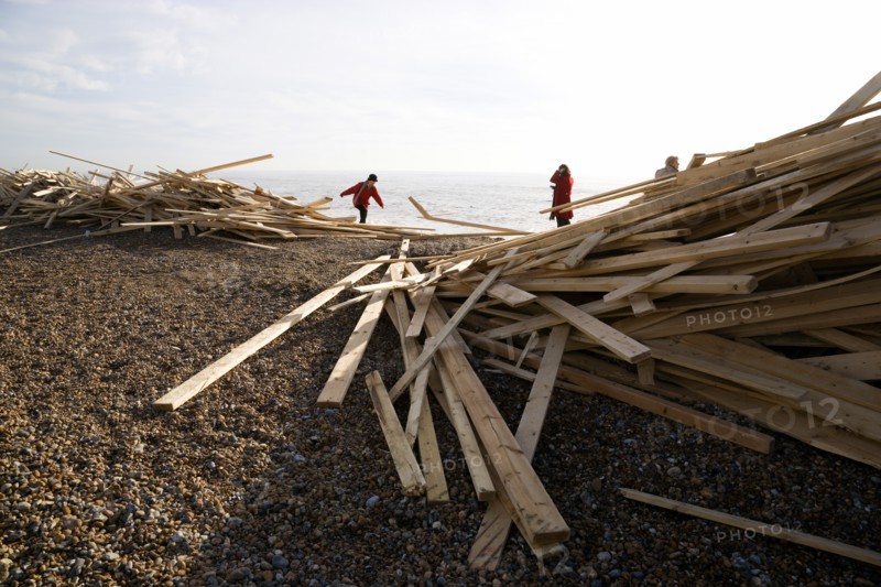 ENGLAND, West Sussex, Worthing, Timber washed up on the beach from the Greek registered Ice Princess which sank off the Dorset coast on 15th January 2008. People walk among the debris