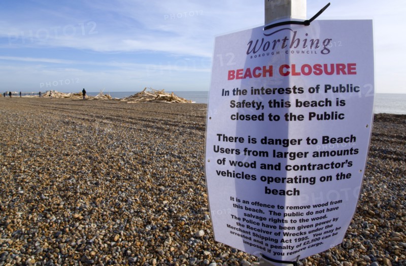 ENGLAND, West Sussex, Worthing, Timber washed up on the beach from the Greek registered Ice Princess which sank off the Dorset coast on 15th January 2008. A sign warns people to keep off the beach which they ignore