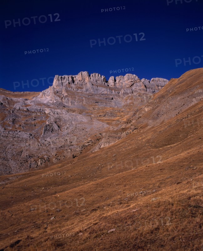 SPAIN, Aragon, Pyrenees, Sierra de la Escusana.  Mountain landscape with eroded rock pinnacles and layers of rock and scree.