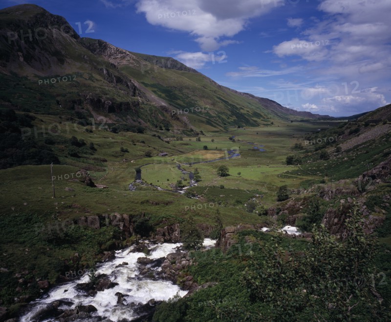 WALES, Gwynedd, Snowdonia National Park, "View west over Nant Ffrancon Valley from Ogwen Falls.  River winding across valley floor with small cultivated fields and pasture between steep, eroded hillsides."