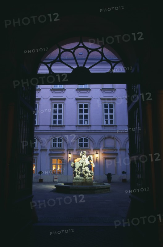 SLOVAKIA, Bratislava, Primacialny or Primate’s Palace.  Inner arcaded courtyard with fountain with statue of St George and the dragon at its centre framed by archway.