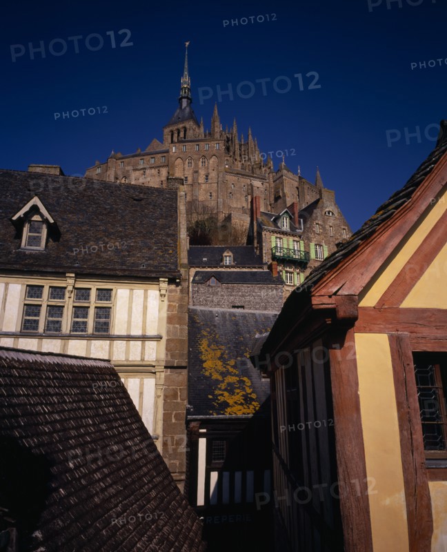 FRANCE, Normandy, Mont-St-Michel, The Abbey on hilltop above houses seen from Liberty Tower.