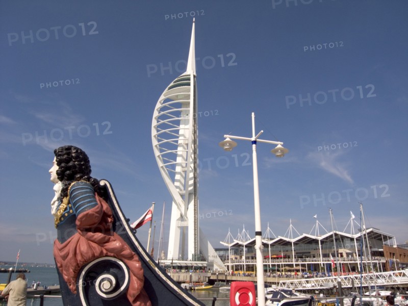 ENGLAND, Hampshire, Portsmouth, Gunwharf Quays. The Spinnaker Tower with figurehead in the foreground