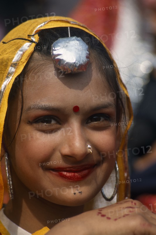 INDIA, Punjab, Kila Raipur, Portrait of a young girl dancer smiling at the Rural Sports Festival