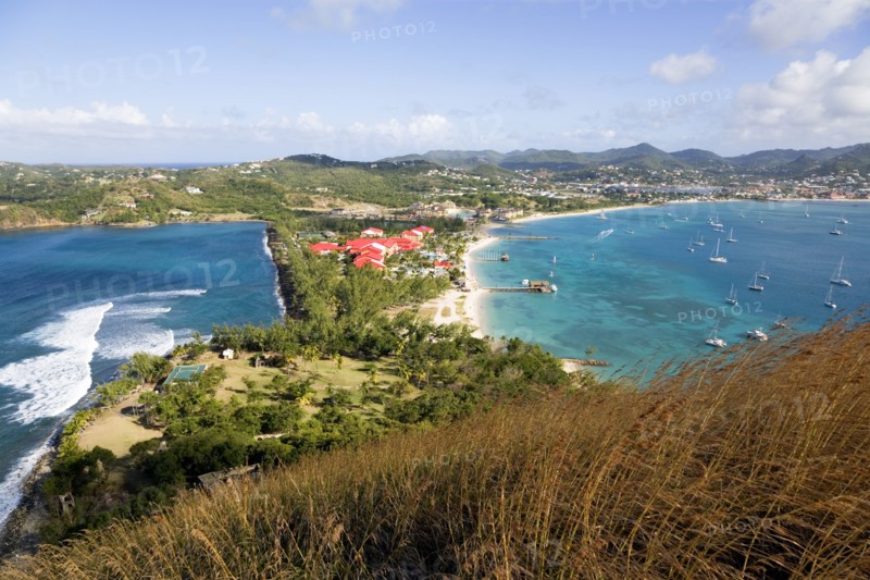 WEST INDIES, St Lucia, Gros Islet , The isthmus leading to Pigeon Island seen from Signal Hill within the National Historic Park with the Atlantic Ocean on the left and the Caribbean of Rodney Bay on the right