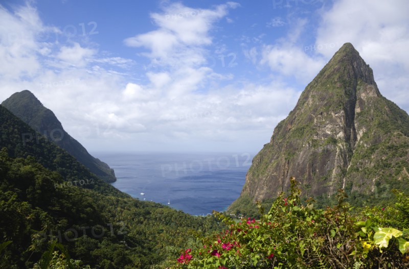 WEST INDIES, St Lucia, Soufriere , Val des Pitons The volcanic plugs of Gros Piton on the left and Petit Piton on the right with the lush valley seen from the sun deck of the Ladera Spa Resort Hotel