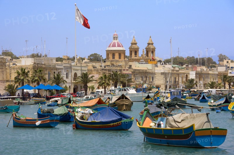 MALTA, Marsaxlokk , Fishing village harbour on the south coast with colourful Kajjiki fishing boats and the Church dedicated to Our Lady of the Rosary The Madonna of Pompeii