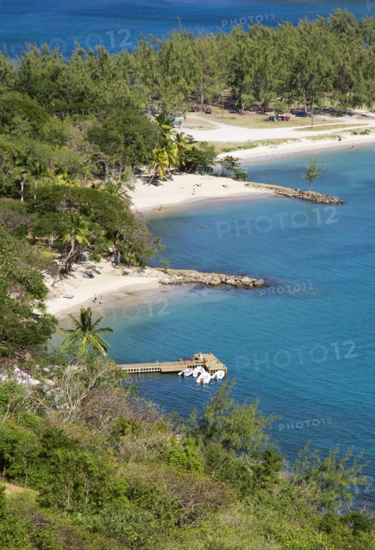 WEST INDIES, St Lucia, Gros Islet , Pigeon Island National Historic Park Small crescent shaped beaches and a wooden jetty set amongst coconut palms and casuarina trees