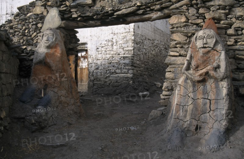 NEPAL, Annapurna Circuit Trek, Male and female Animistic protector guardians by the entrance gateway to Jharkot.