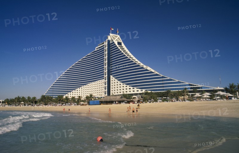 UAE, Dubai , Jumeirah Beach Hotel with people on private beach in foreground.