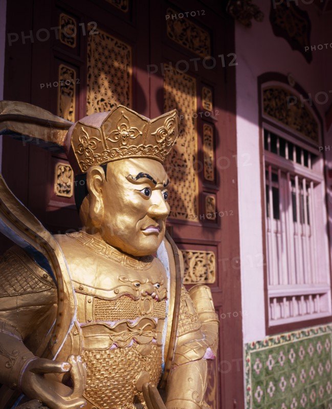 MALAYSIA, Penang, Georgetown, Gold painted statue outside wholesaler shopfront during Chinese New Year.