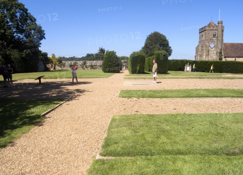 ENGLAND, East Sussex, Battle, Battle Abbey. Visitors in grounds of partially ruined abbey complex near to the spot that King Harold fell in the 1066 Battle of Hastings