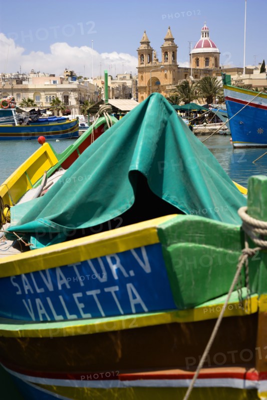 MALTA, Marsaxlokk , Fishing village harbour on the south coast with colourful Kajjiki fishing boats and the Church dedicated to Our Lady of the Rosary The Madonna of Pompeii