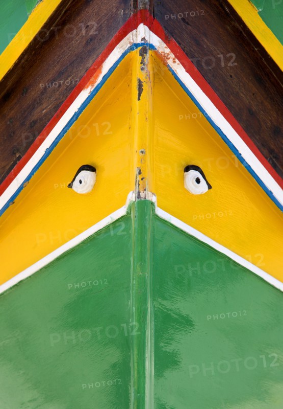 MALTA, Marsaxlokk , Fishing village harbour on the south coast with colourful Kajjiki fishing boat with the Eyes of Osiris on the bow
