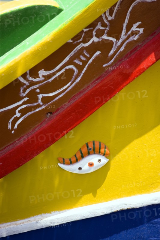 MALTA, Marsaxlokk , Fishing village harbour on the south coast with colourful Kajjiki fishing boat with the Eyes of Osiris on the bow