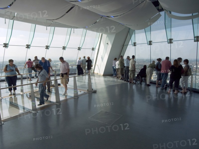 ENGLAND, Hampshire, Portsmouth, "Gunwharf Quays. The Spinnaker Tower. Interior view with visitors looking out of glass windows on the top observation deck, providing a 320° view of the city of Portsmouth, the Langstone and Portsmouth harbours, and a viewing distance of 37 kilometres (23 miles)"