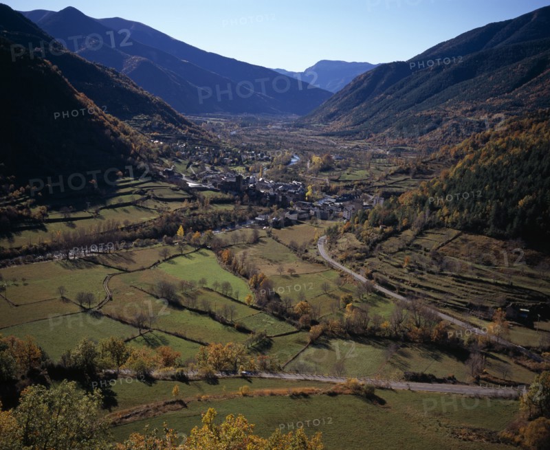 SPAIN, Aragon, Huesca, Village of Broto on valley floor and surrounding landscape in Autumn colours.