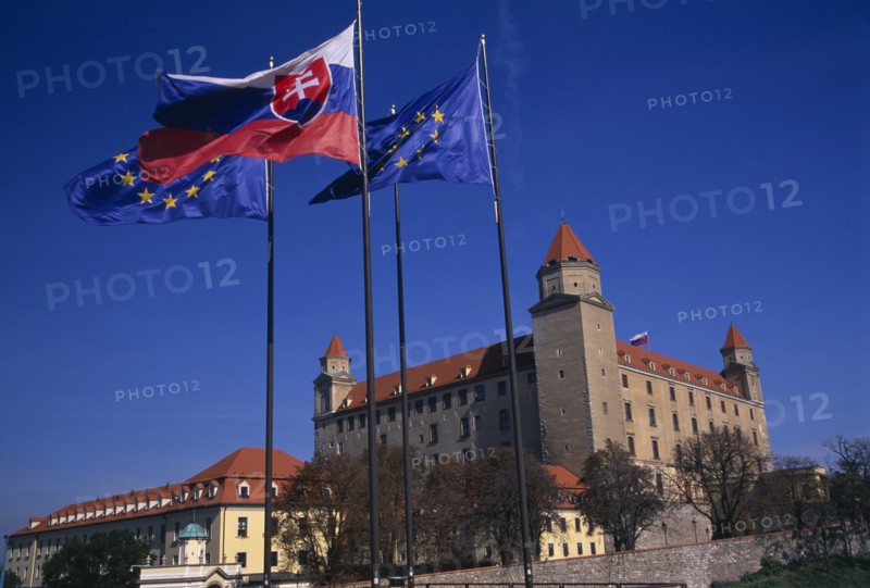 SLOVAKIA, Bratislava, "Flags flying outside Bratislava Castle, reconstructed 1956-68 after burning down.  Part of the compound continues to be used by the Slovak Parliament."