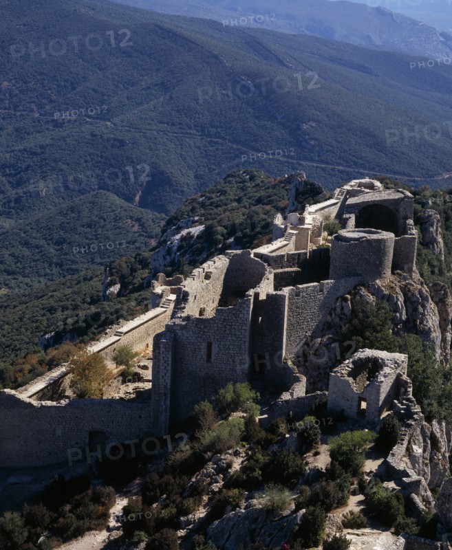 FRANCE, Languedoc-Roussillon, Aude, "Chateau Peyrepertuse.  Ruined medieval Cathar castle stronghold, lower section situated on steep rocky mountainside high above surrounding landscape."