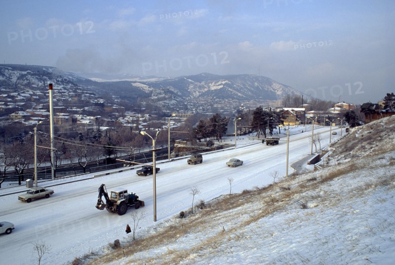 GEORGIA, Tbilisi, Cityscape and traffic in snow.