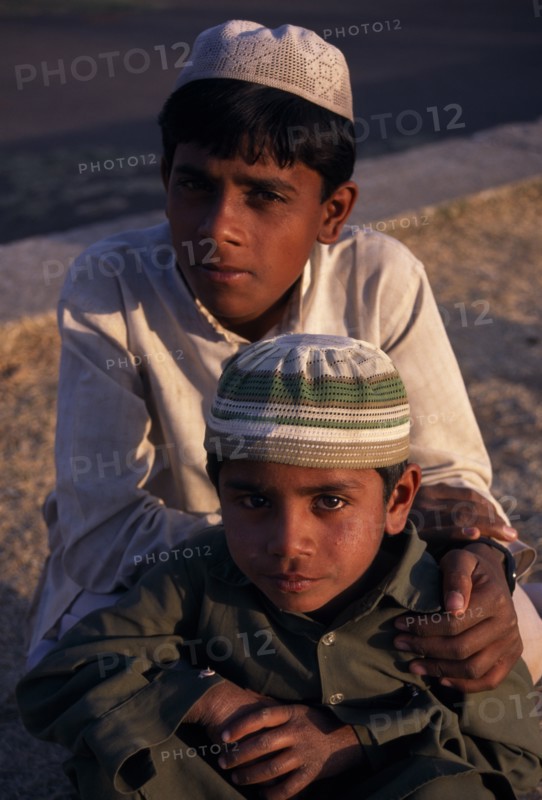 INDIA, Madhya Pradesh, Bhopal, "Head and shoulders portrait of two, young Muslim boys."