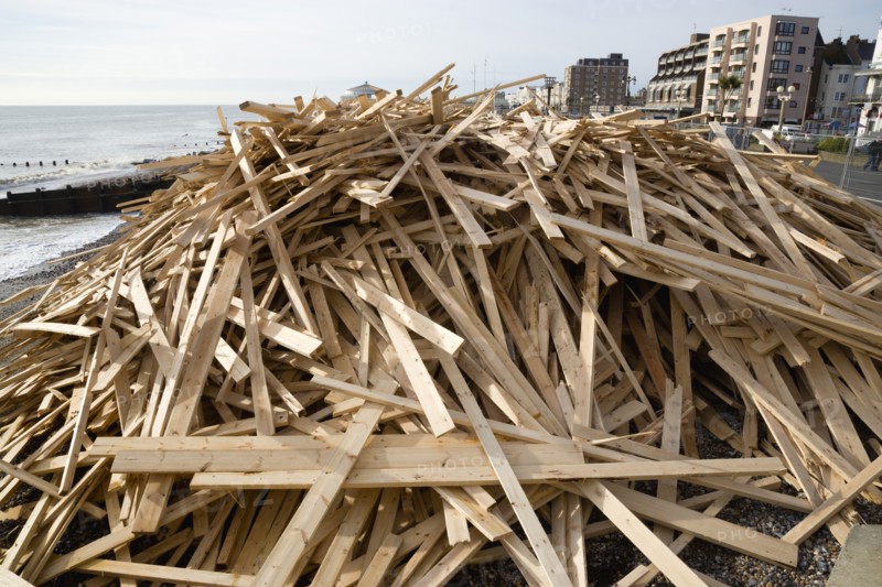 ENGLAND, West Sussex, Worthing, Timber washed up on the beach from the Greek registered Ice Princess which sank off the Dorset coast on 15th January 2008. Seafront flats beyond