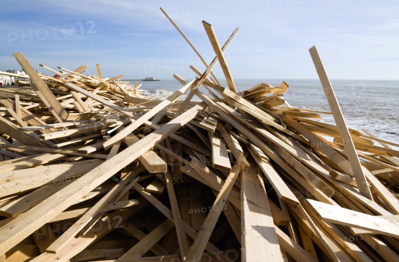 ENGLAND, West Sussex, Worthing, Timber washed up on the beach from the Greek registered Ice Princess which sank off the Dorset coast on 15th January 2008. Worthin Pier in the distance