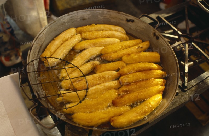 MEXICO, Mexico City, Fried bananas for sale on market stall.