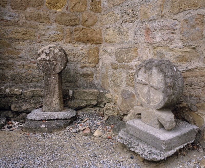 FRANCE, Languedoc-Roussillon, Aude, Montmaur.  Disc shaped crosses outside the Eglise St Baudile thought to be associated with the Cathars.