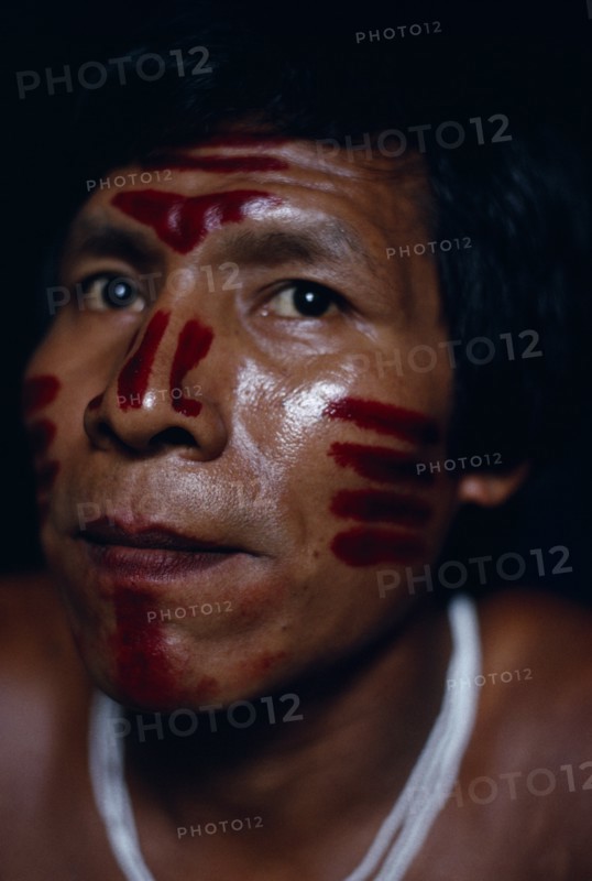 COLOMBIA, North West Amazon, Tukano Indigenous Tribe,  Portrait of Venancio Makuna (sub-group of Tukano) headman Ignacio's son  decorated with red Achiote facial paint for dance/manioc ceremony