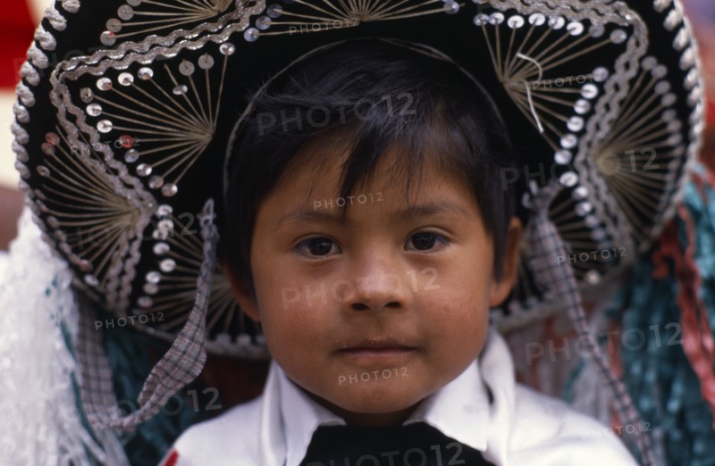 MEXICO, Puebla, Huejotzingo, Head and shoulders portrait of young boy dressed for carnival.
