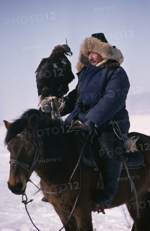 CHINA, Xinjiang, People, Kazakh horseman with hunting eagle on his hand.
