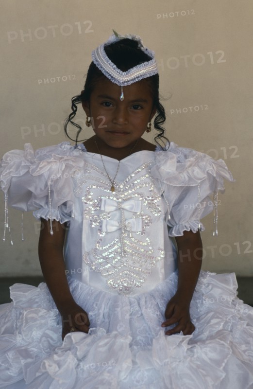 MEXICO, Oaxaca, Mitla, Portrait of young girl dressed in white on the day of her first communion.