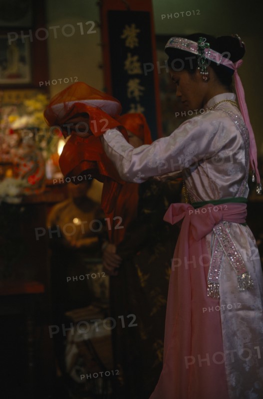 VIETNAM, North, Religion, Woman raising covered offerings of fruit seeking contact with the spirit world through trance.