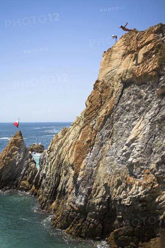 MEXICO, Guerrero State, Acapulco, "Cliff diver, a clavadista, diving off the cliffs at La Quebrada"