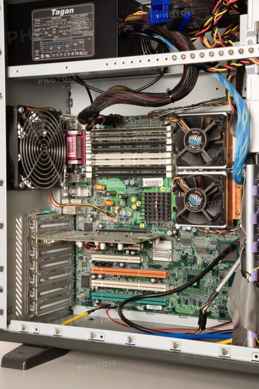 INDUSTRY, Machinery, Computers, "Desktop PC personal computer with the side panel off showing the power unit, case extractor fans, double processors with fans, motherboard, cables, RAM memory cards and slots, and PCI network card with spare slots"