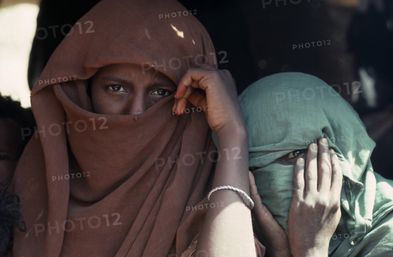 20088677 SUDAN Red Sea Hills Province People Head and shoulders portrait of two Beja nomad Arab girls  veiled so that only their eyes are visible.
