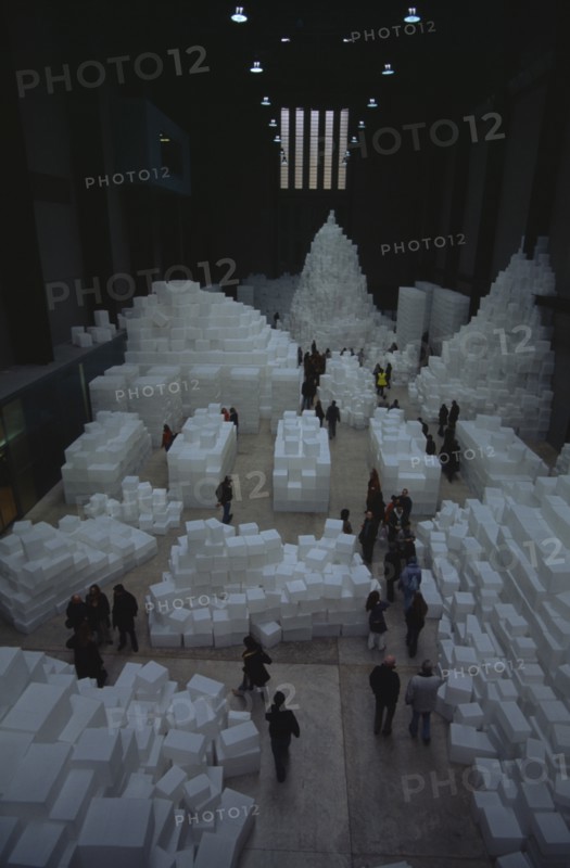 ENGLAND, London, "Tate Modern. Turbine Hall. Exhibition by Rachel Whiteread called Embankment. 14,000 transluscent white polyethylene boxes stacked in various ways. View looking down over visitors walking around exhibit."