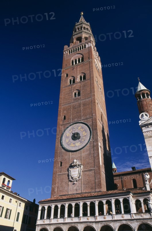 ITALY, Lombardy, Cremona, Piazza del Comune.  Medieval bell tower known as the Torrazzo linked by a Renaissance loggia to the Duomo.  Clock on exterior featuring the signs of the zodiac.