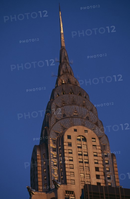USA, New York, New York City, Part view of the Chrysler Building from East 42nd Street lit by golden light.  Steel framed Art Deco skyscraper built 1928-1930 and designed by architect William Van Alen.