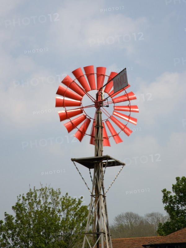 ENGLAND, West Sussex, Amberley, Amberley Working Museum. Orange wind vane pump