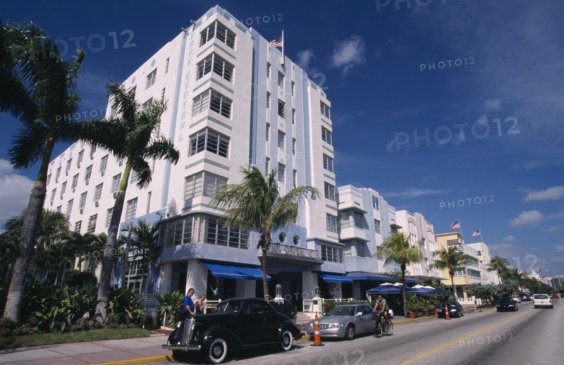 USA, Florida, Miami , South Beach. Ocean Drive. Art Deco Park Central Hotel  exterior lined with palm trees and cars parked outside
