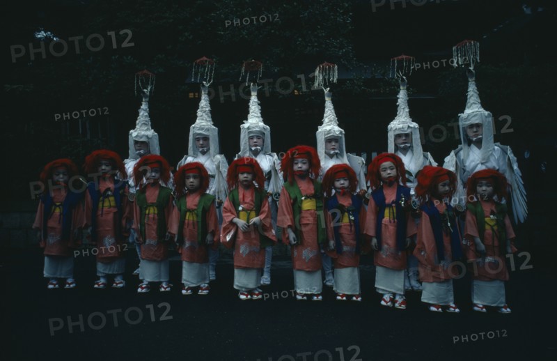JAPAN, Honshu, Kyoto, Gion Festival.  Children dressed for Shinto dances pose for photographer at the Yasaka Shrine.