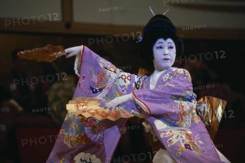 JAPAN, Honshu, Tokyo, Use of traditional Geisha dances in modern choreography.  Female dancer with fans in afternoon show in the Kabuki Theatre.