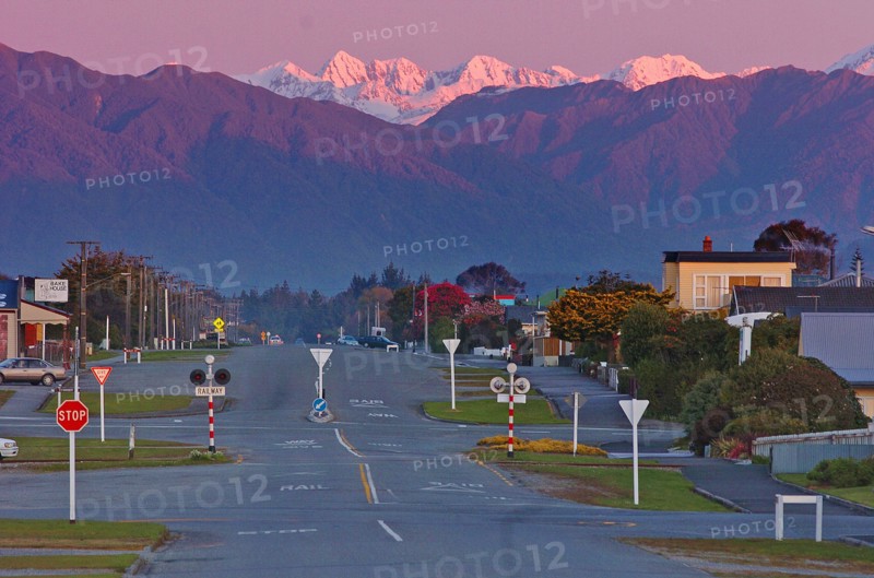 NEW ZEALAND, SOUTH ISLAND, WEST COAST, "HOKITIKA, DUSK LOOKING THE LENGTH OF PARK STREET EAST INLAND TOWARDS THE SOUTHERN ALPS FROM THE HOKITIKA COAST ROAD."