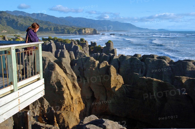 NEW ZEALAND, SOUTH ISLAND, PUNAKAIKI, "GEOLOGICAL FEATURED ROCKS CALLED THE PANCAKE ROCKS BLOWHOLES AT DOLOMITE POINT, PUNAKAIKI ON THE SOUTH ISLAND WEST COAST.THE ROCK HAS SPLIT INTO HORIZONTAL LAYERS TO RESEMBLE A TOWER OF PANCAKES."