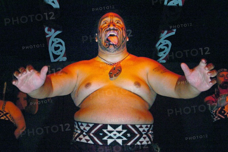 NEW ZEALAND, NORTH ISLAND, BAY OF PLENTY, "ROTORUA, THE HARKA WAR DANCE PERFORMED BY MAORI AT THE TAMAKI MAORI VILLAGE PERFORMED IN THE WHENUAI OR BIG HOUSE 15 MILE SOUTH OF ROTORUA."