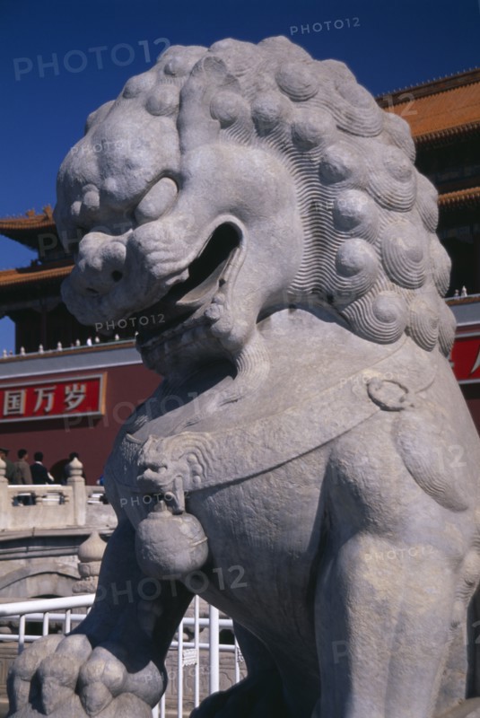 CHINA, Beijing, Stone statue of lion at entrance gateway to the Forbidden City from Tiananmen Square.